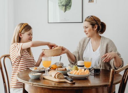 A warm family breakfast with mother and daughter sharing a meal in a cozy dining area.