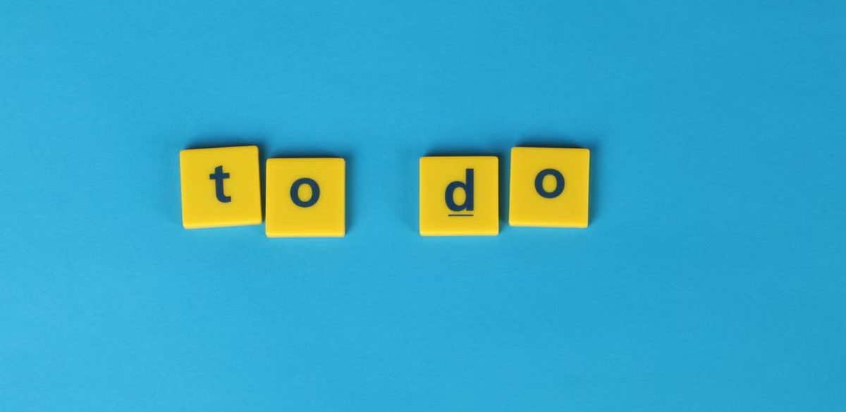Yellow letter tiles spelling 'to do' against a vibrant blue background for organizational themes.