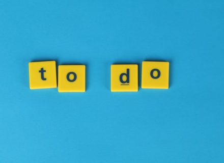 Yellow letter tiles spelling 'to do' against a vibrant blue background for organizational themes.