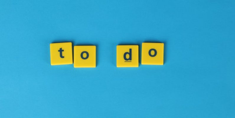 Yellow letter tiles spelling 'to do' against a vibrant blue background for organizational themes.